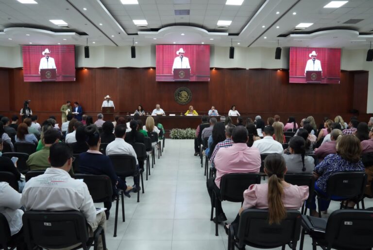 Decenas de personas sentadas frente a presidium en salón Constituyentes de 1917.